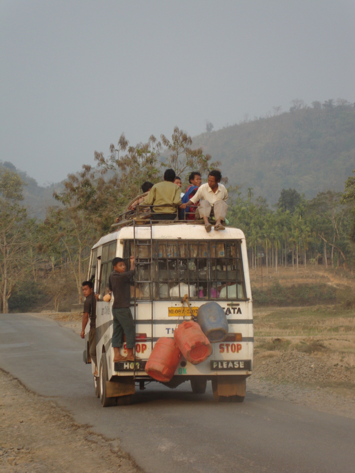 Adaptive reuse and interpretive flexibility: Decommissioned intra-city buses now serve for long-range transportation in the Garo Hills. Passengers ride on the bus wherever they can find space.