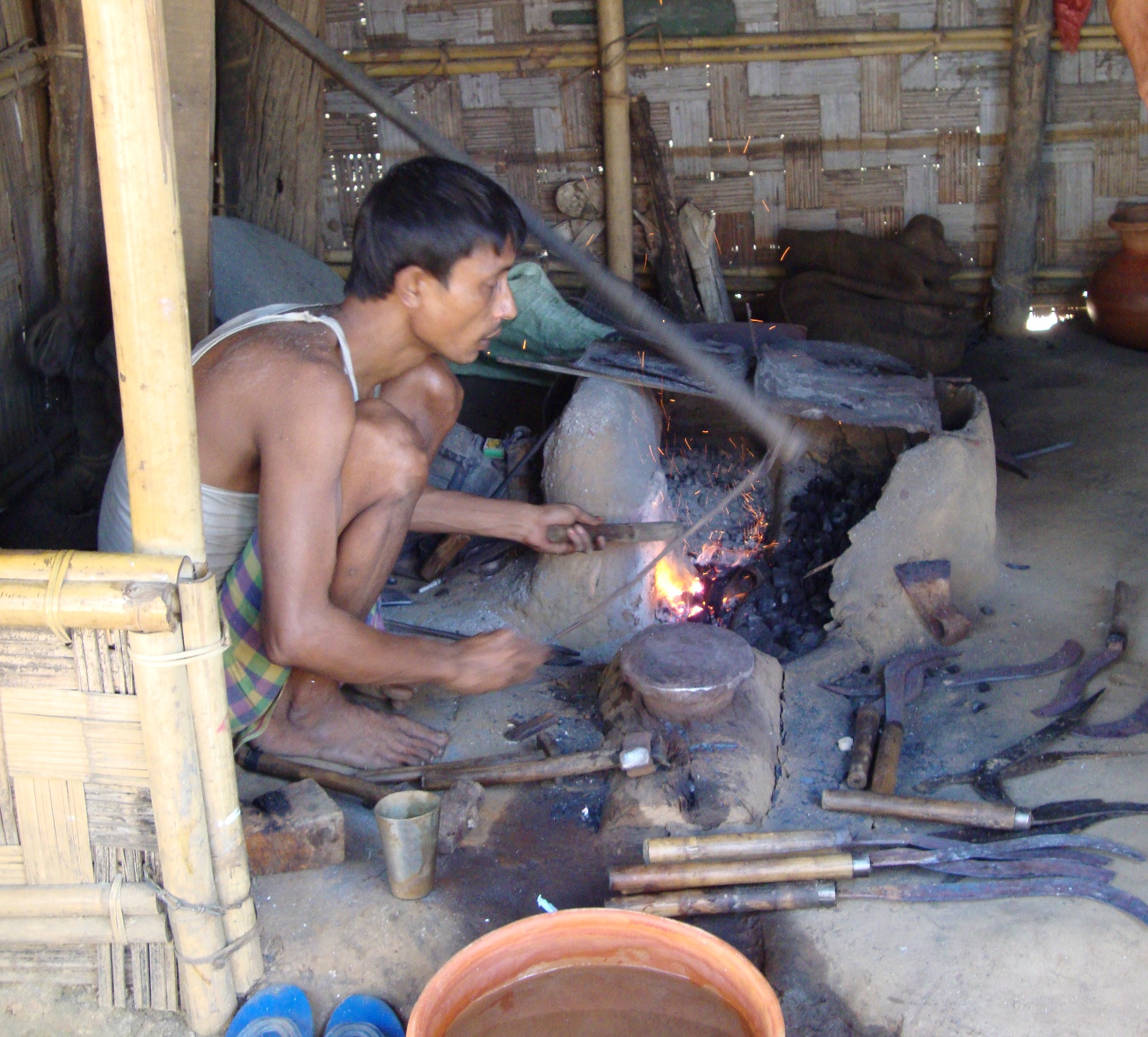 A blacksmith making tools for everyday use in the Garo Hills.