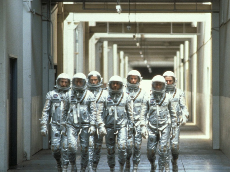 Seven of the masculine heroes of The Right Stuff. This corridor scene has been endlessly imitated and parodied. (Warner Home Video)