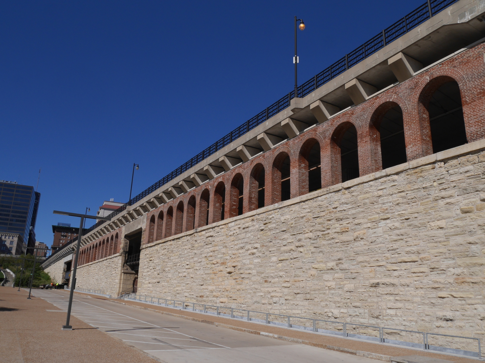 The imposing stone approach works on the Missouri side of the bridge. The upper deck of the bridge carries vehicles and pedestrian traffic, and the lower deck has tracks for the Metrolink streetcar system.