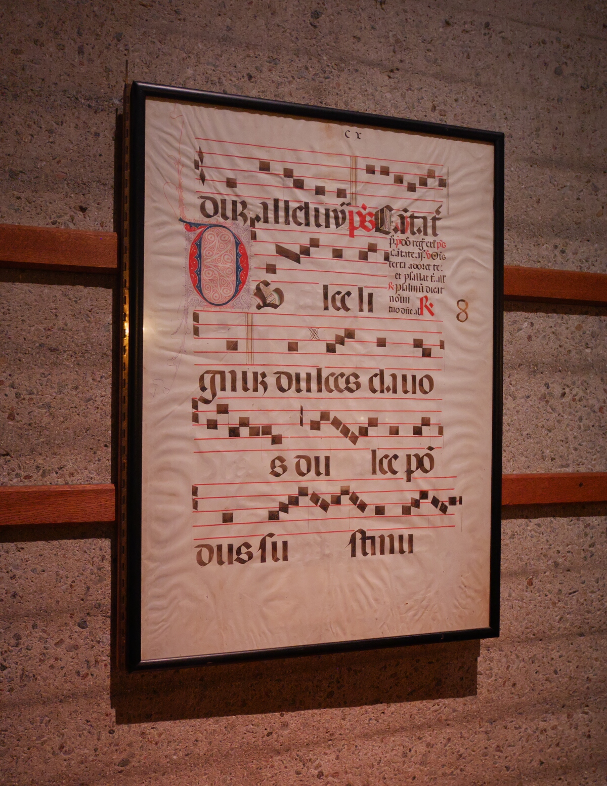 Some archaic musical notation mounted on the wall.