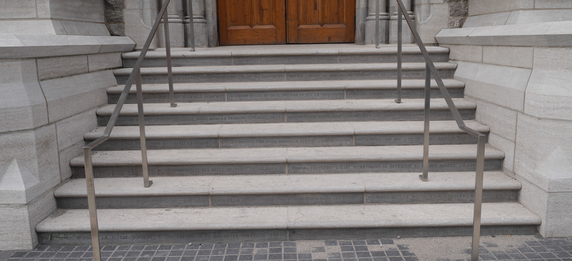 The story of Trinity Anglican Church is inscribed in the reconstructed steps below the doorway.