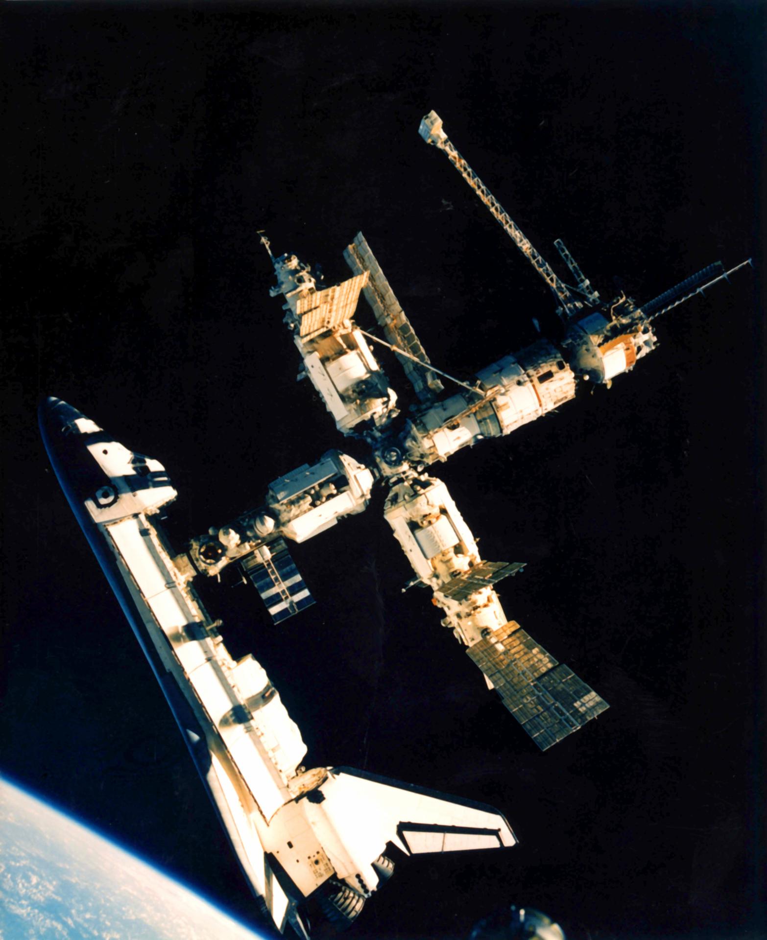 Space shuttle Atlantis docked with space station Mir