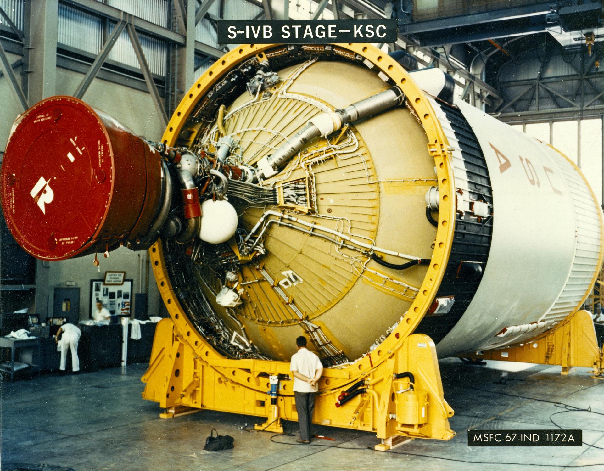 An S-IVB stage with a technician at Kennedy Space Center.