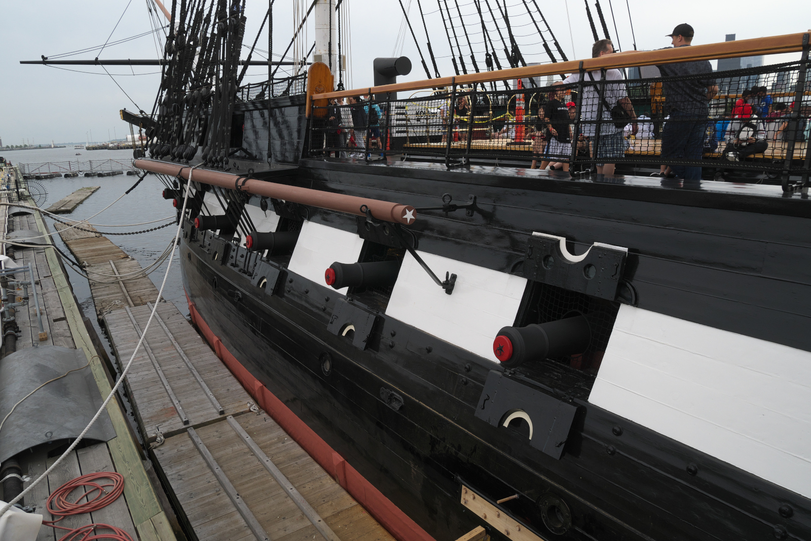 Port side of the USS Constitution, with the cannons protruding from their ports on the gun deck.