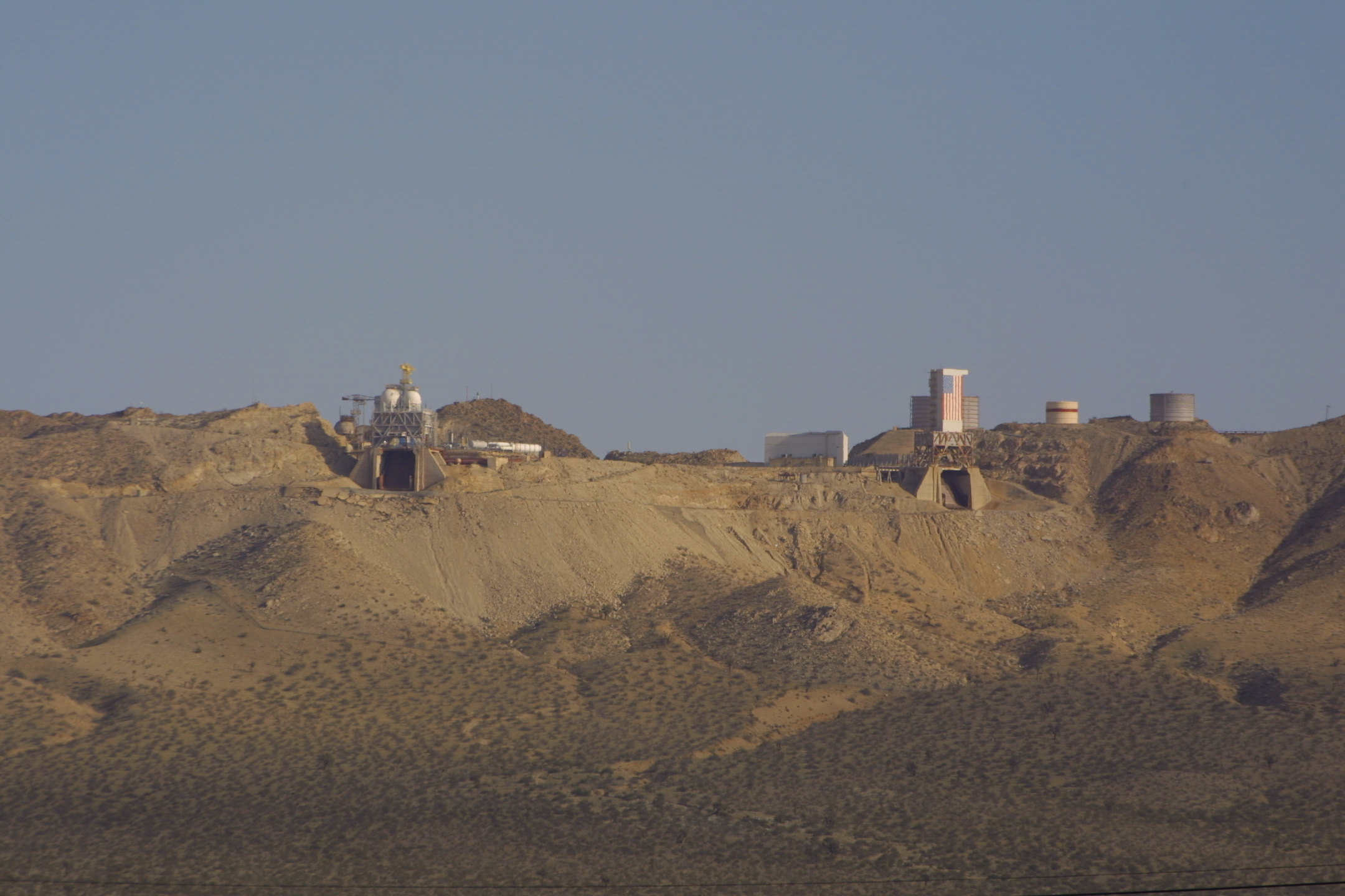 Apollo-era test stands on Leuhman Ridge: 1-D (L) and 1-C (R). Test Stand 1-C has been modified from its original configuration with the addition of a white tower on top, but 1-D looks about as it did in the 1960s. Test Stand 1-B is out of view to the right.