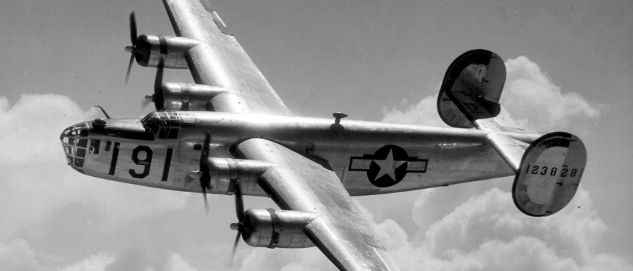 A Consolidated B-24 Liberator from Maxwell Field, Alabama, four engine pilot school, glistens in the sun as it makes a turn at high altitude in the clouds.