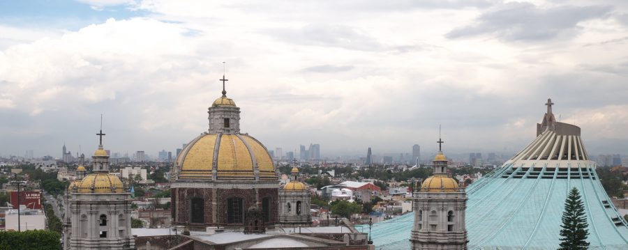 Villa de Guadalupe with Mexico City skyline in the distance.